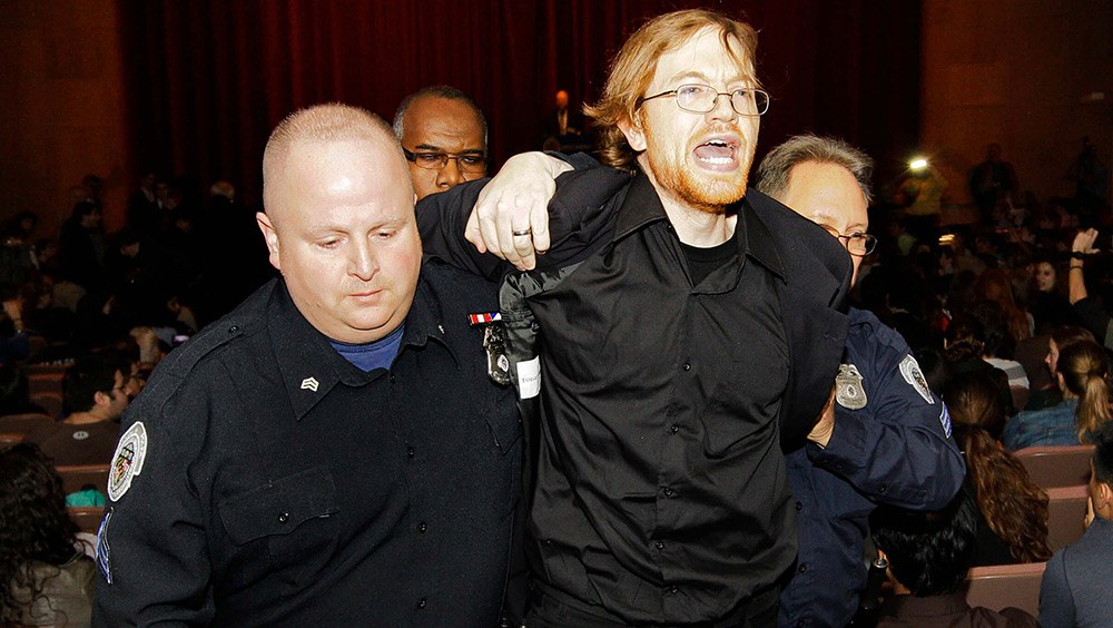 A heckler is removed by Johns Hopkins University police after he interrupted a speech by Karl Rove, former Deputy Chief of Staff and Senior Policy Advisor to President George W. Bush, in Baltimore in 2011.
