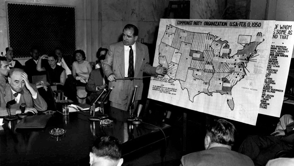 Sen. Joseph McCarthy points to a map headed "Communist party organization U.S.A.-Feb. 9, 1950," during a 1954 testimony in Washington, D.C.