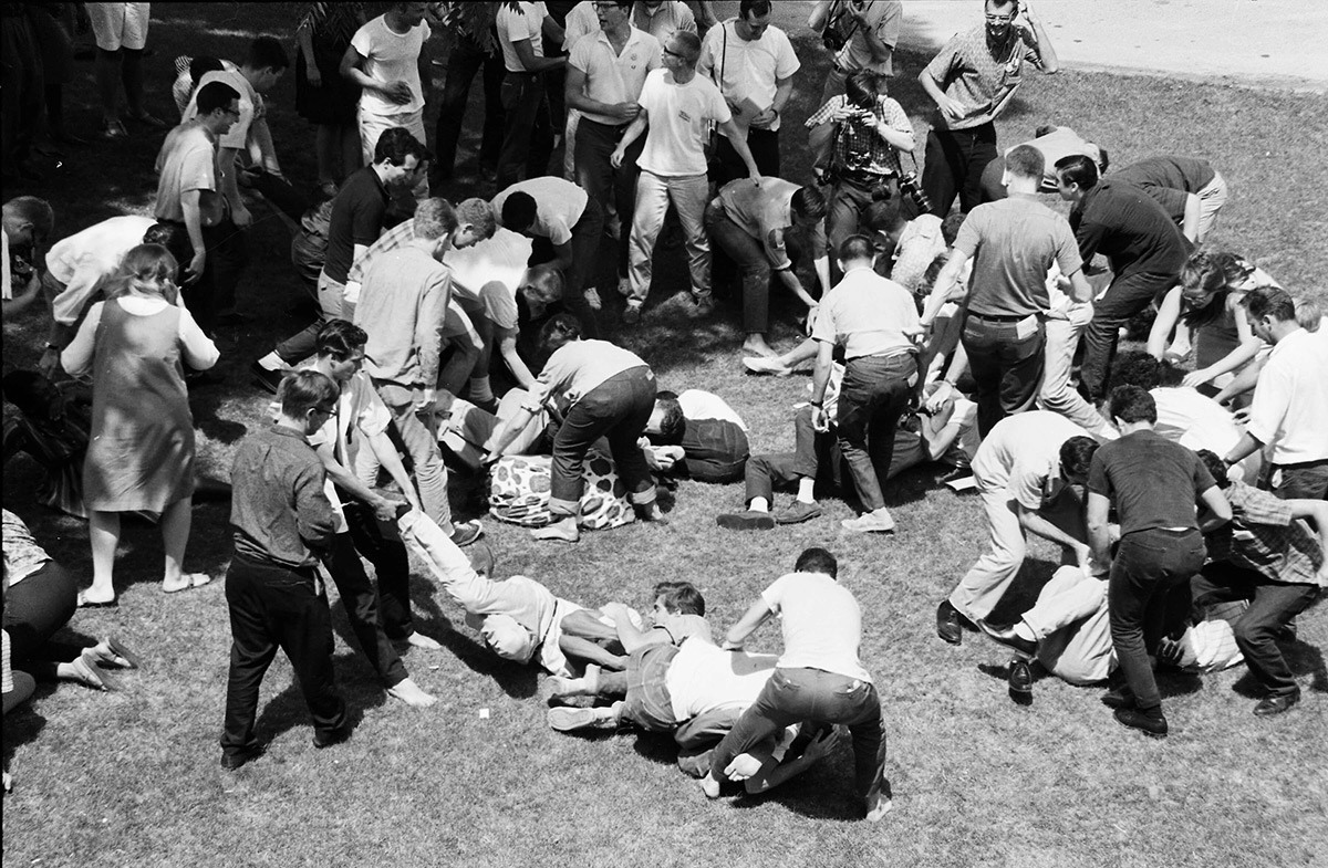 Freedom Summer 1964 volunteers participate in self-protection training during a mock attack. Some volunteers curl up on the ground.