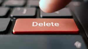 Person pressing delete button representing internet history and right to be forgotten