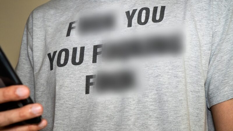 controversial shirt with blurred out expletives