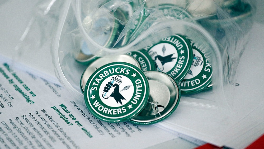 Pro-union pins on a table during a watch party for Starbucks