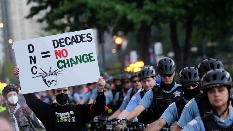 Protesters march past a police line prior to the start of the 2024 Democratic National Convention.