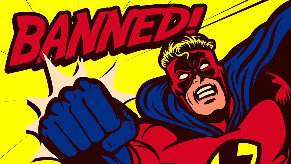 Comic book illustration of superhero punching with the word "banned!" on screen