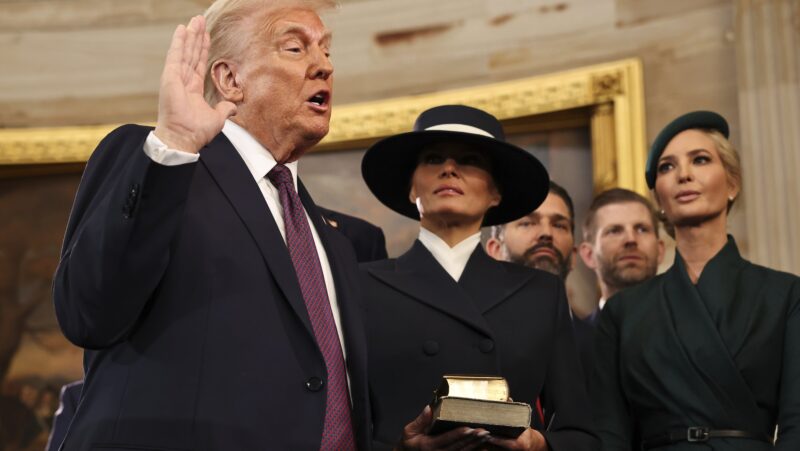 Donald Trump takes the oath of office as his wife Melania and his children look on during inauguration ceremonies in the Rotunda of the U.S. Capitol on January 20, 2025 in Washington, DC.